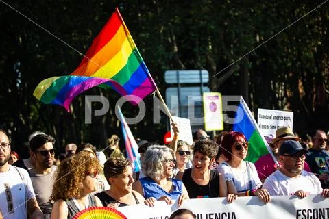 Crowd Of People On Pride Month Rainbow Flags And Posters In Support Of