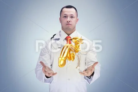 Doctor With Stethoscope And Golden Penis On The Hands In A Hospital