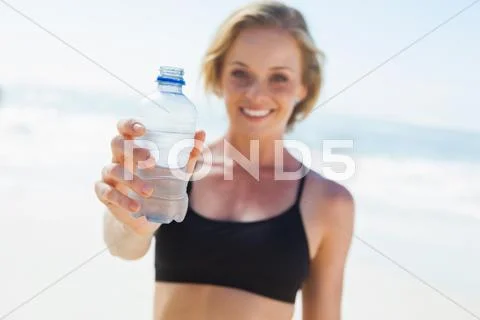 Fit Blonde Drinking Water On The Beach Stock Image 39698386