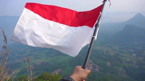 Hand Holding Indonesia Flag On Blue Sky Stock Video Pond5