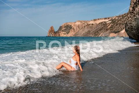 Happy Woman In Bikini Sits On The Sea Beach Tanned Girl Sunbathing On