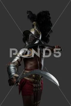 Naked Roman Gladiator With Two Swords And Plumed Helmet Stock Photo