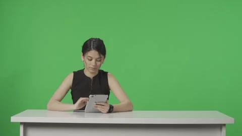 A Tv Presenter Sits At A Table In The St Stock Video Pond