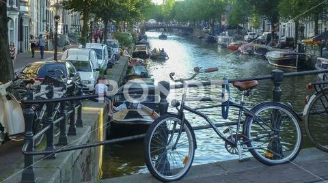 Bicycle and people on Amsterdam canal, Netherlands