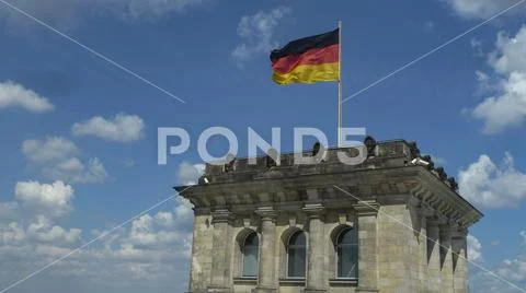Tower of the Reichstag parliament with german flag in Berlin, Germany