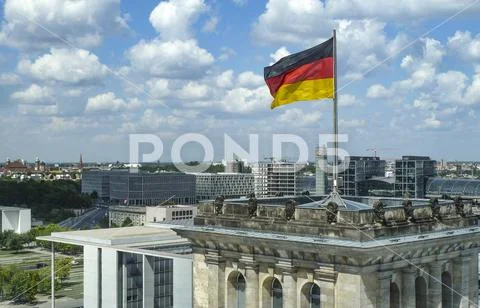 View of downtown Berlin and the main train station with german flag from the Reichstag parliament