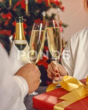 Couple celebrating christmas toasting with sparkling wine