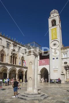 Tourists at Sponza palace and city gate with tower, Dubrovnik, Croatia