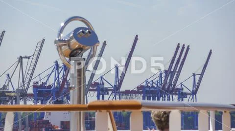 Dock cranes with telescope from the deck of a cruise ship