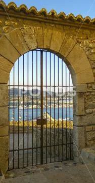 View through gate of the bay of Ibiza town Eivissa, Spain