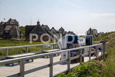Sylt, tourists in a beach chair on the dune boardwalk