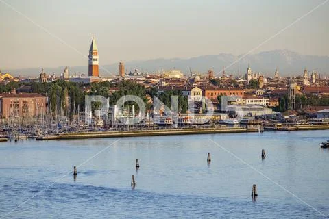 Suburb of Venice, Italy with harbor and Alps