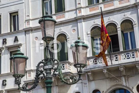 Detail shot, historical street lamp in front of facade in Venice, Italy