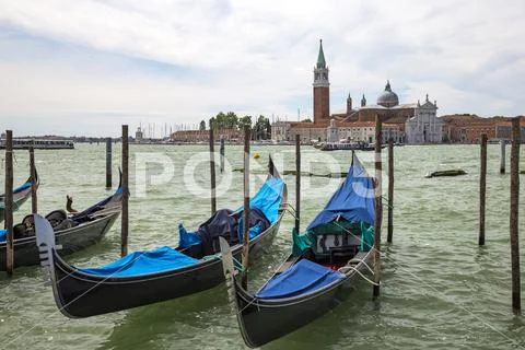 Empty gondolas in Venice with Isola San Giorgio, Italy
