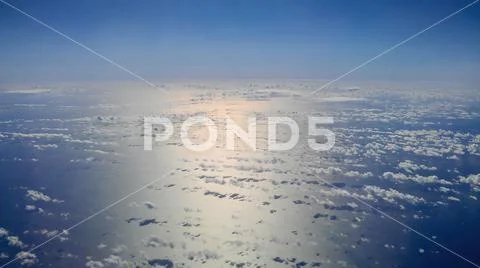 View from the plane, sea surface with clouds