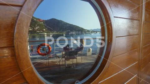 Porthole with Tortola Bay and ship deck