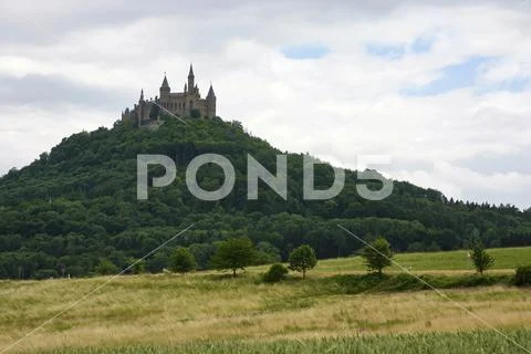 Hohenzollern Castle on top of mountain with road sign