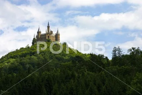 Hohenzollern Castle on top of mountain with road sign