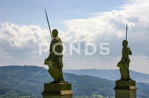 Knight statues with a lance looking into the valley