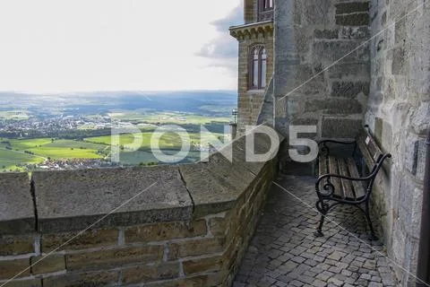 Bench on the castle wall with a view of the valley