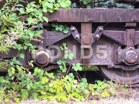 Old wagon axles in the industrial park in the disused industrial area