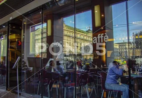 Reflection of historical facades in cafe glass