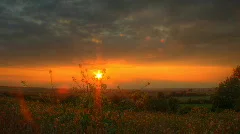 HDR motion time lapse clip of sunset over fields