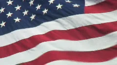Closeup of real USA flag waving against dark blue sky