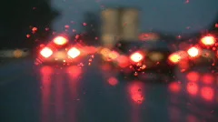 Rainy highway. Defocused brake lights.