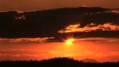 Dramatic Orange Sunset, Clouds and Mountains in Silhouette - Time Lapse