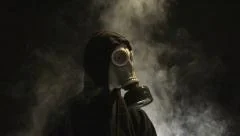 Man in Gas Mask with Smoke Rising