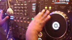 Overhead shot of DJ hands on turntable.