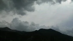 Clouds Billow Over Dark Mountain Silhouette Timelapse
