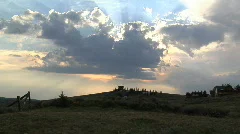 Heavenly Clouds Pass Before a Setting Sun Above a Rural Landscape Timelapse