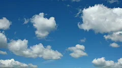 Motion background - white clouds flying on blue sky
