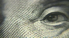 Eye macro on dollar bill rotating