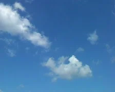 Time lapse background - white clouds flying on blue sky