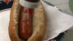 Putting Ketchup on Sausage
