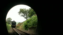 Steam train entering tunnel