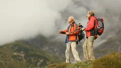 two senior hikers on hilltop