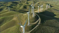 Aerial view of wind turbines in green hillside