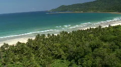 Aerial over beautiful tropic beach with forest in the background