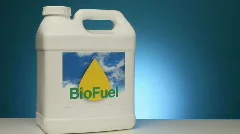 Container of biofuel with beaker of corn