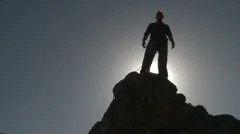 Climber silhouetted on mountaintop HD