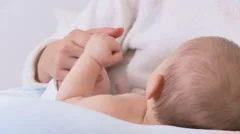 Mother holding babys hand