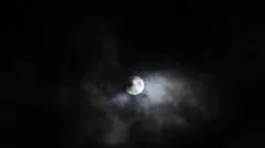 Blue Full Moon in the Night Sky With Passing Clouds