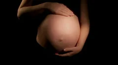 Pregnant woman strokes tummy (HD)