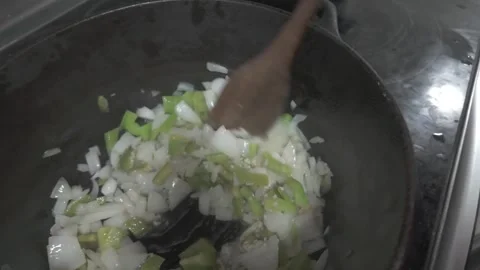 0010Boiling Cast Iron Pot on Stove With Wooden Spoon Stirring Steaming Bean soup Stock Footage 337727815