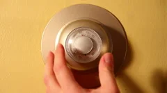 Adjusting a Round Home Thermostat Dial