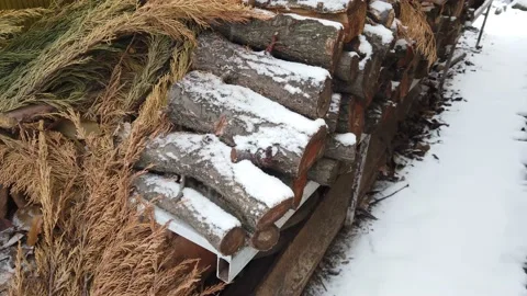 002 Falling snow on the background of firewood Video stock 147351556